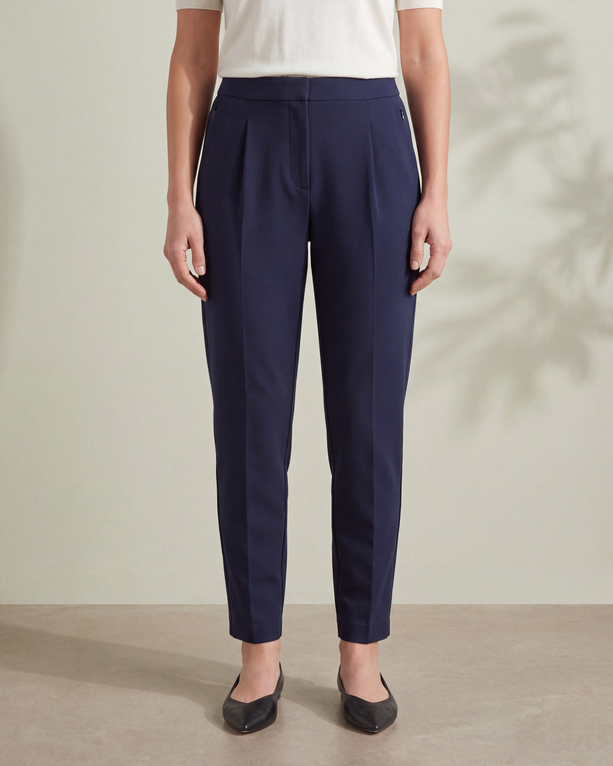 TRAVEL Ink navy tapered trousers, close front view