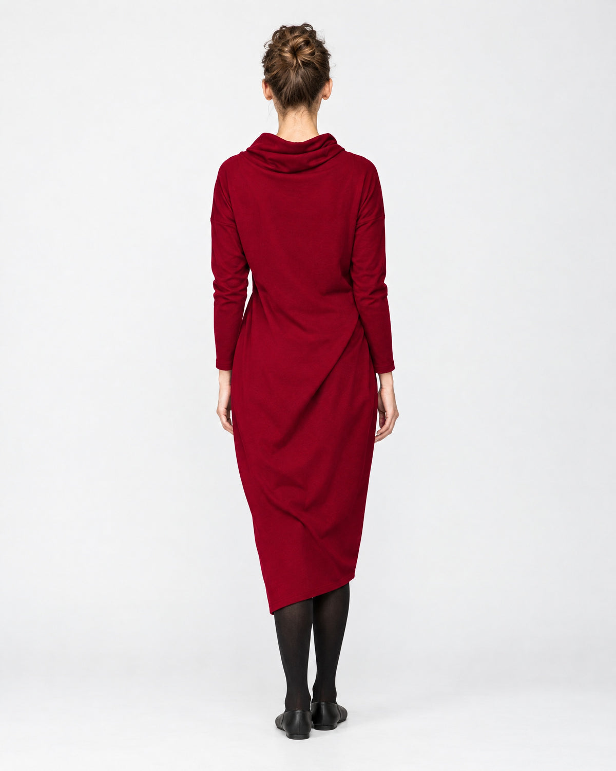 A woman wearing a dark red long-sleeve cowl-neck midi dress with side pockets, back view, studio background. #Color_Red