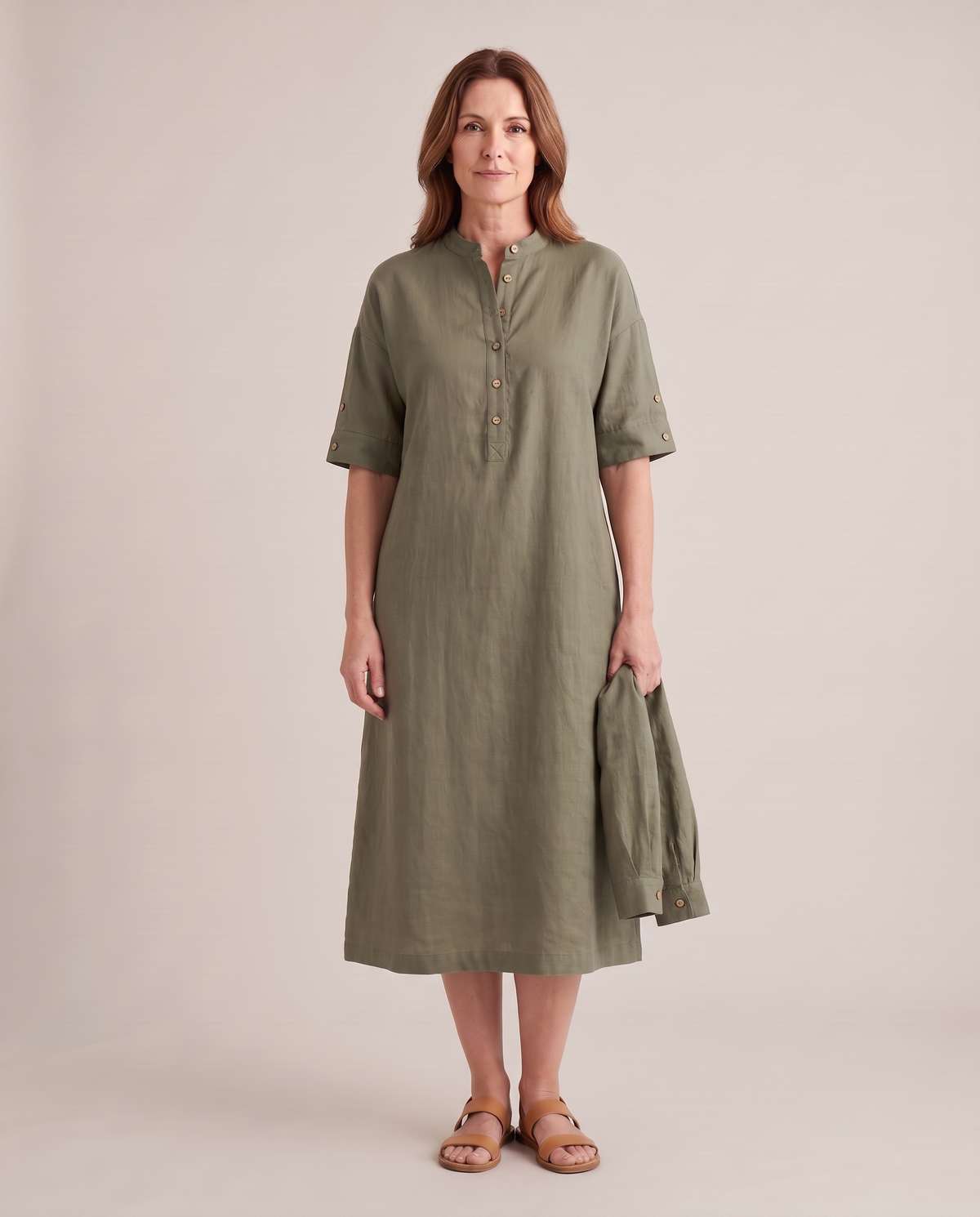 VERA linen midi dress in Olive Green worn with short sleeves, detached long sleeves in hand
