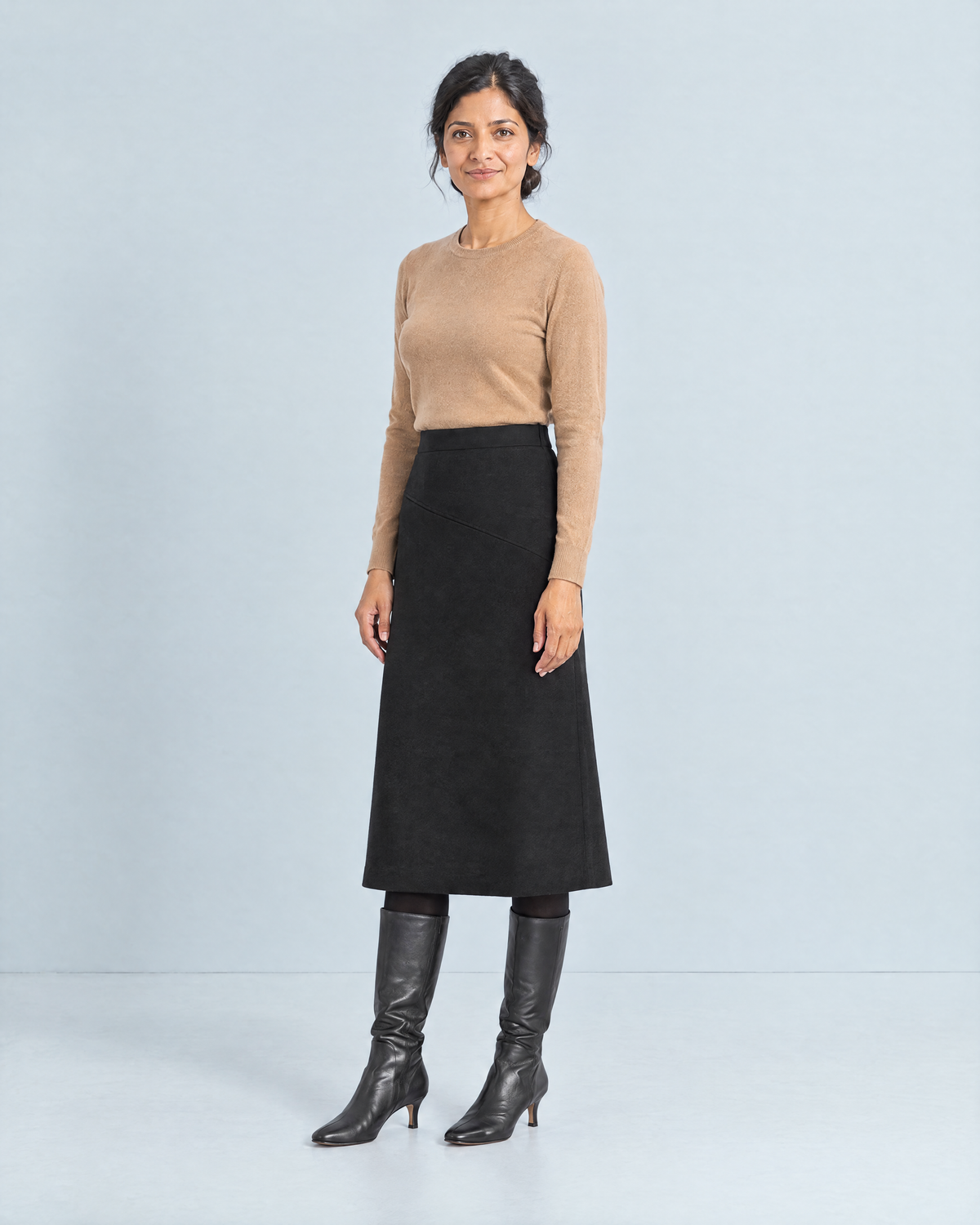 WINTER MIDI wool midi skirt in Black, three-quarter view
